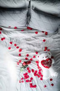 valentines bedroom white bed cover with rose buds