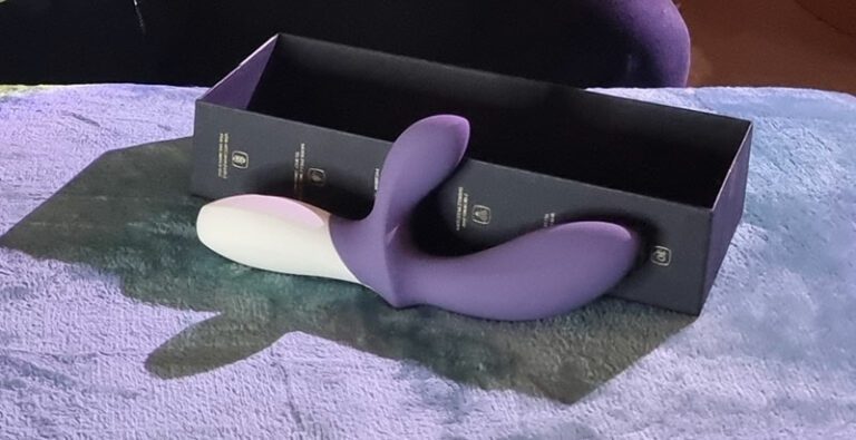 lelo loki wave 2 massager purple with a white handle in front of its box