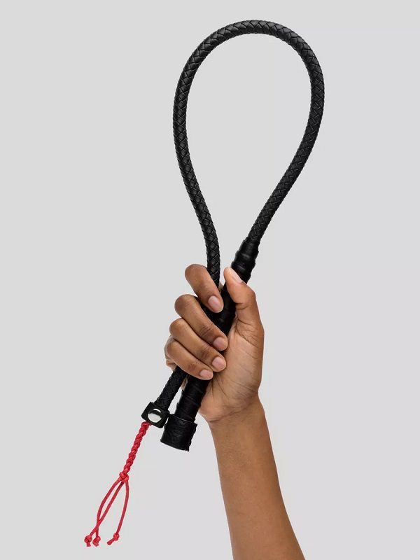 A hand holding the Bondage Boutique Faux Leather Rope Whip